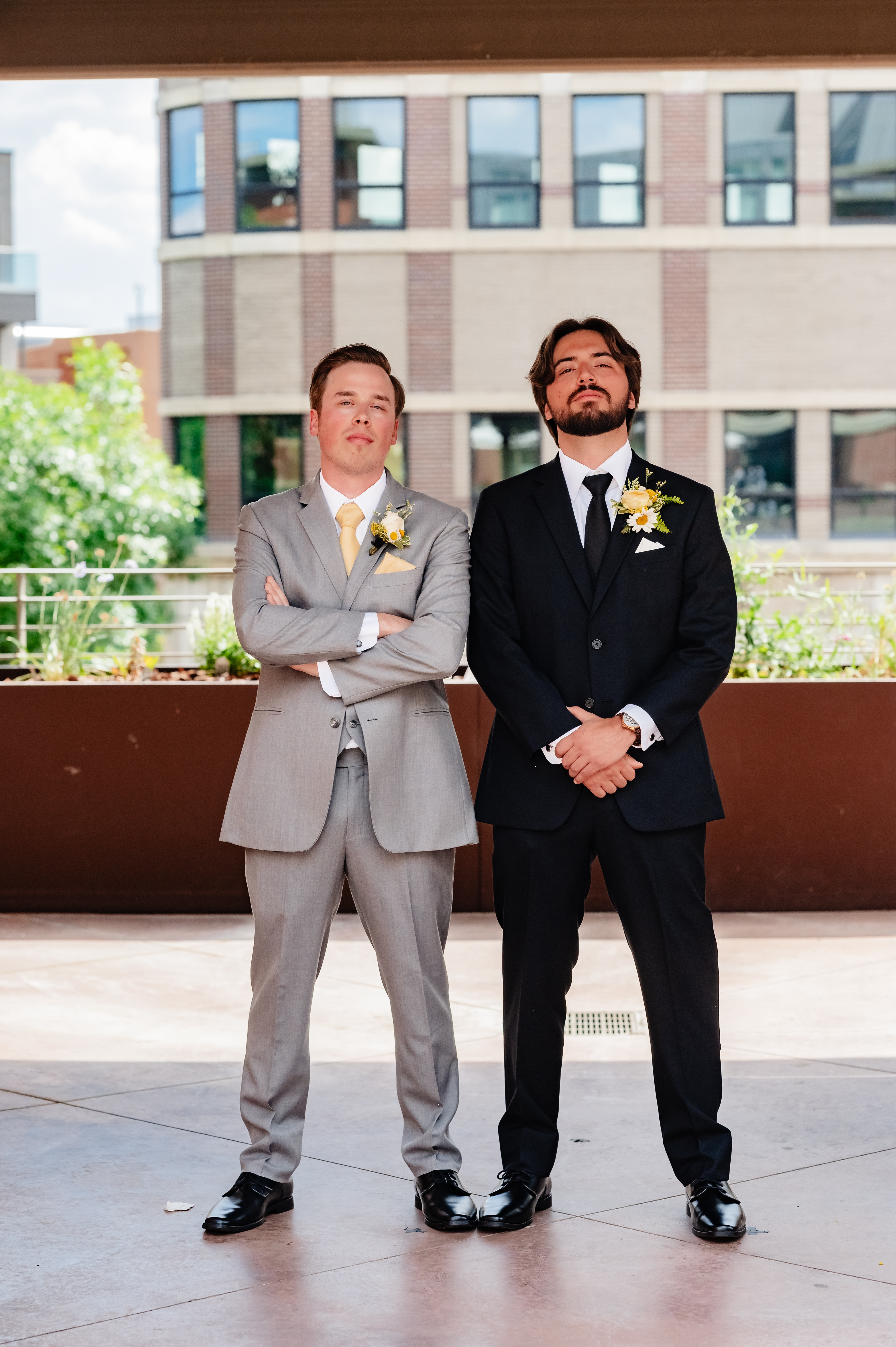 Noah and Nick dressed in suits at a formal event